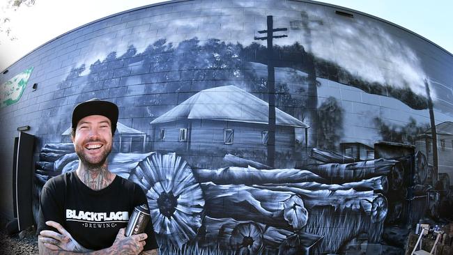 A mural of the old Nambour saw mill is being created for the Nambour heritage trail by street artist Ross Holloway. Picture: Patrick Woods.