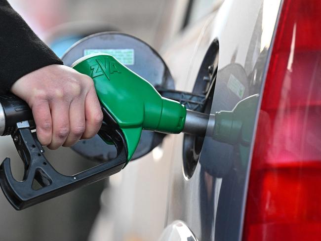 (FILES) In this file photo taken on March 08, 2022 A woman fills up her car with diesel at a petrol station in Mulhouse, eastern France, on March 8, 2022. - The French government has announced a package worth 2.0 billion euros ($2.2 billion) to help consumers struggling with soaring fuel prices, with the cost of filling up set to be cut at the pump. (Photo by SEBASTIEN BOZON / AFP)