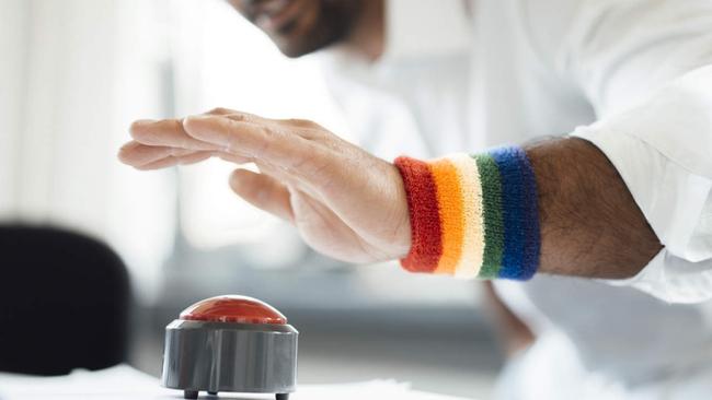 Businessman with hand poised on game show buzzer at office