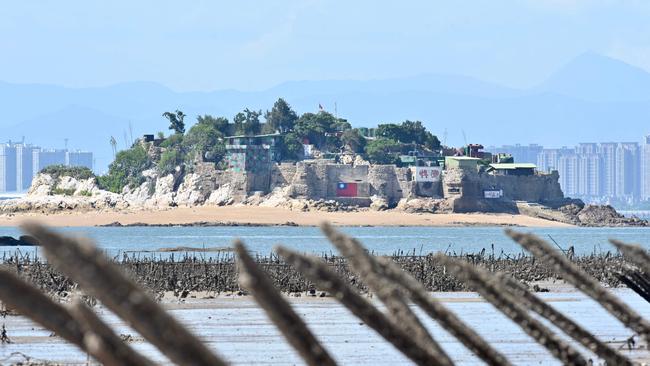 A Taiwanese military outpost on Shihyu islet is seen past anti-landing spikes placed along the coast of Lieyu islet on Taiwan's Kinmen island. Picture: AFP.