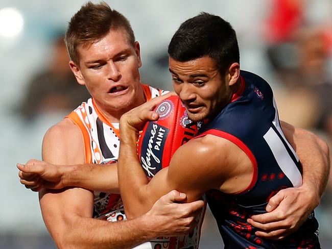 MELBOURNE, AUSTRALIA - MAY 26: Billy Stretch of the Demons is tackled by Adam Tomlinson of the Giants during the 2019 AFL round 10 match between the Melbourne Demons and the GWS Giants at the Melbourne Cricket Ground on May 26, 2019 in Melbourne, Australia. (Photo by Michael Willson/AFL Photos)