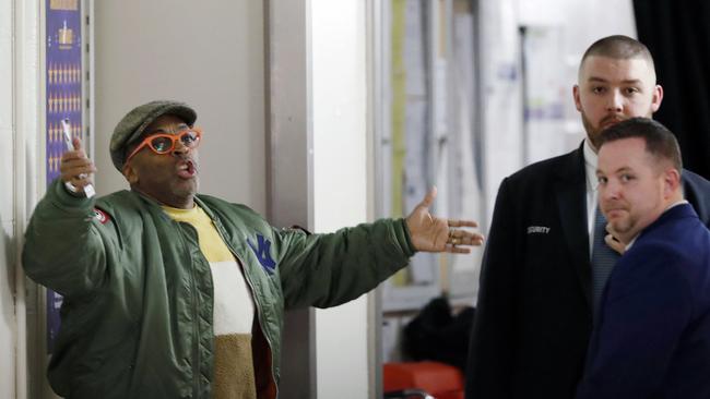 Director Spike Lee, left, gestures in a hallway on the event level at Madison Square Garden while arguing with security officers. Picture: AP Photo/Kathy Willens