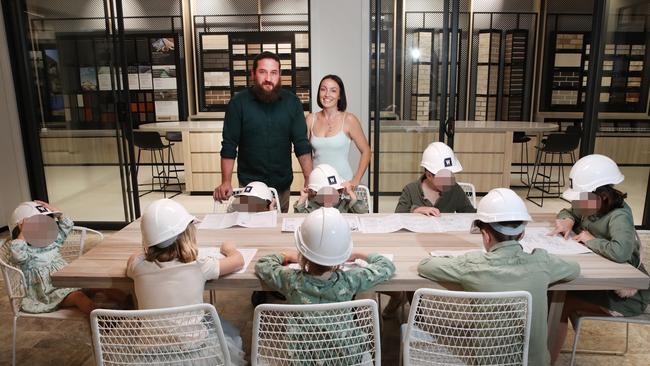 Danielle Carroll and husband Rhys Carroll with their five children and the three children of her sister Kelly Wilkinson at Metricon Homes. Picture: Glenn Hampson