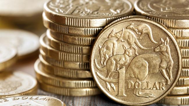 Stacks of Australian one dollar coins. Focus on front coin.