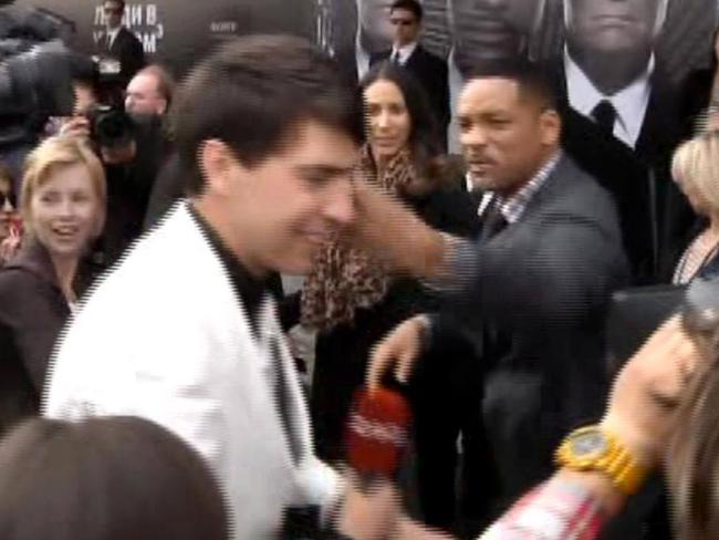 Will Smith gives a backhander to a reporter on the red carpet. Picture: YouTube