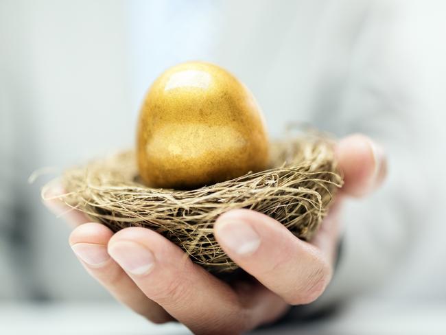 Retirement savings golden nest egg in a businessman's hand, superannuation generic