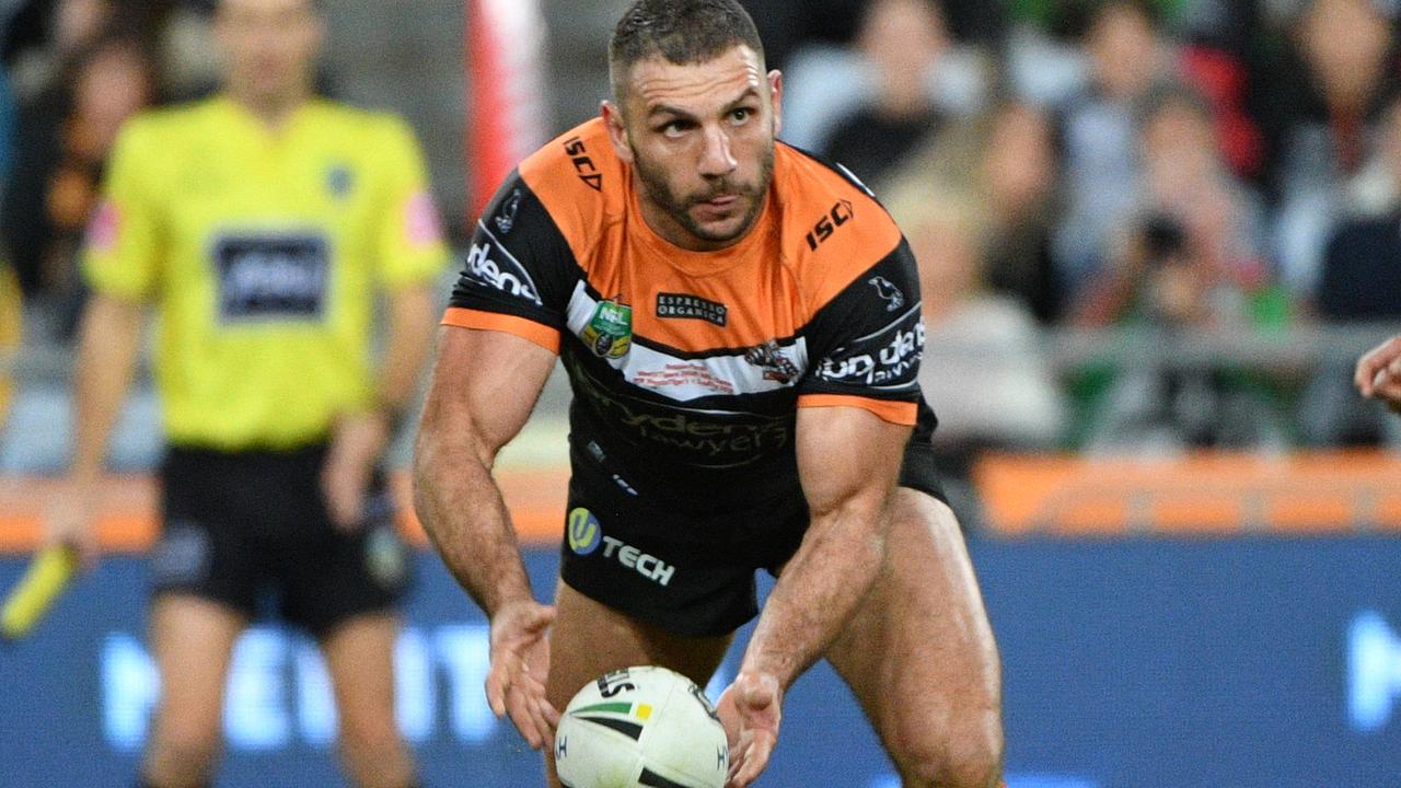 Robbie Farah was in the wars in his 250th milestone match for the Tigers, with a head knock and a thundering Sam Burgess hit sure to leave him sick and sore tomorrow. (AAP Image/Mick Tsikas).