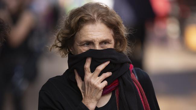 A woman covers her face as she shops at a food market in Tel Aviv, Israel. Picture: AP