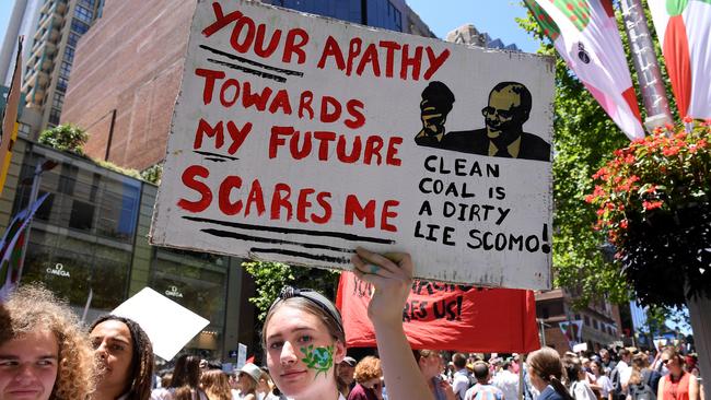 Signs protesting coal show students are not learning enough about economics at school. Picture: AAP/Dan Himbrechts