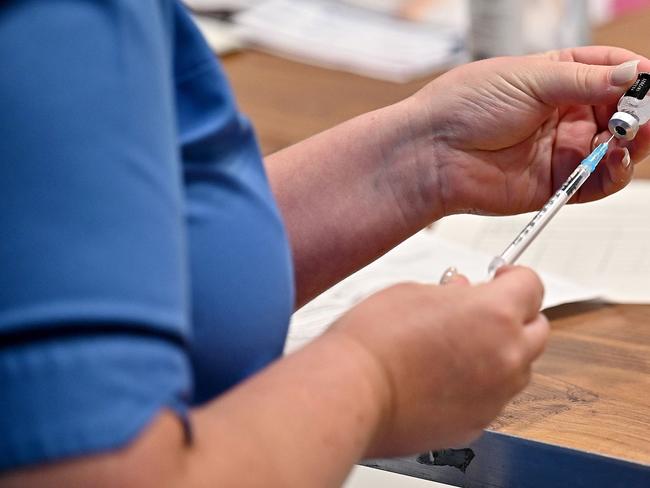 A covid-19 vaccine is prepared at a vaccination centre in Barrhead, south of Glasgow on August 9, 2021, where First Minister Nicola Sturgeon met staff and patients during a visit, to promote continued uptake of the COVID-19 vaccine. (Photo by Jeff J Mitchell / POOL / AFP)