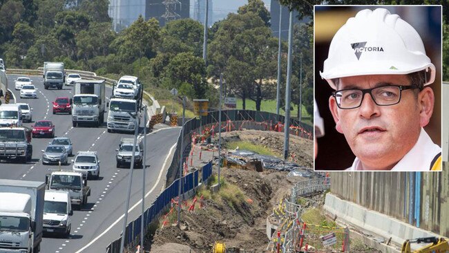 A mound of soil-covered in a black tarp behind the barricades running along the Westgate Freeway and Daniel Andrews (inset). Main picture: Jay Town