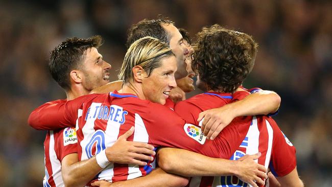 Diego Godin of Atletico Madrid is congratulated by teammates after scoring.