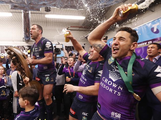 Melbourne's Cameron Smith, Cooper Cronk and Billy Slater sing the team song in the dressing rooms after the 2017 NRL Grand Final between the Melbourne Storm and the North Queensland Cowboys at ANZ Stadium, Sydney. Picture: Brett Costello