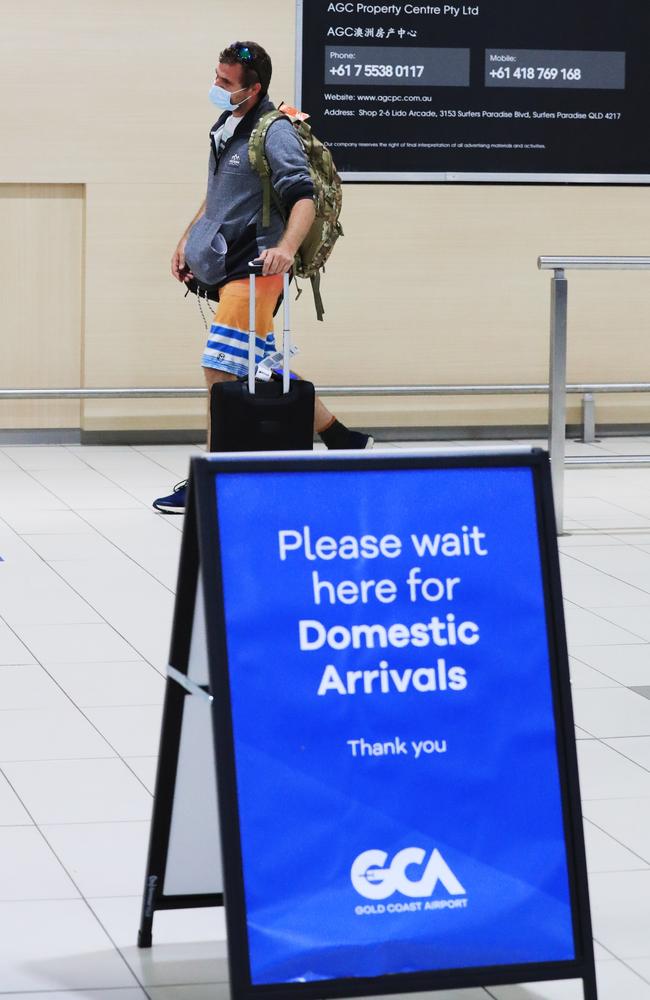 Passengers arrive off the last South Australian flight into the Gold Coast before borders close to South Australia from midnight. Picture: Scott Powick