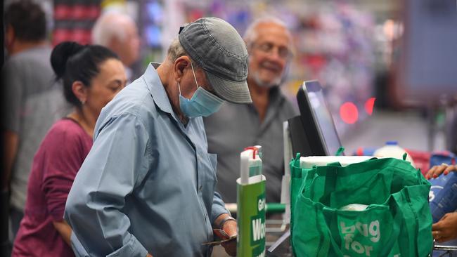 A shopper wears a face masks in Woolworths. Picture: AAP