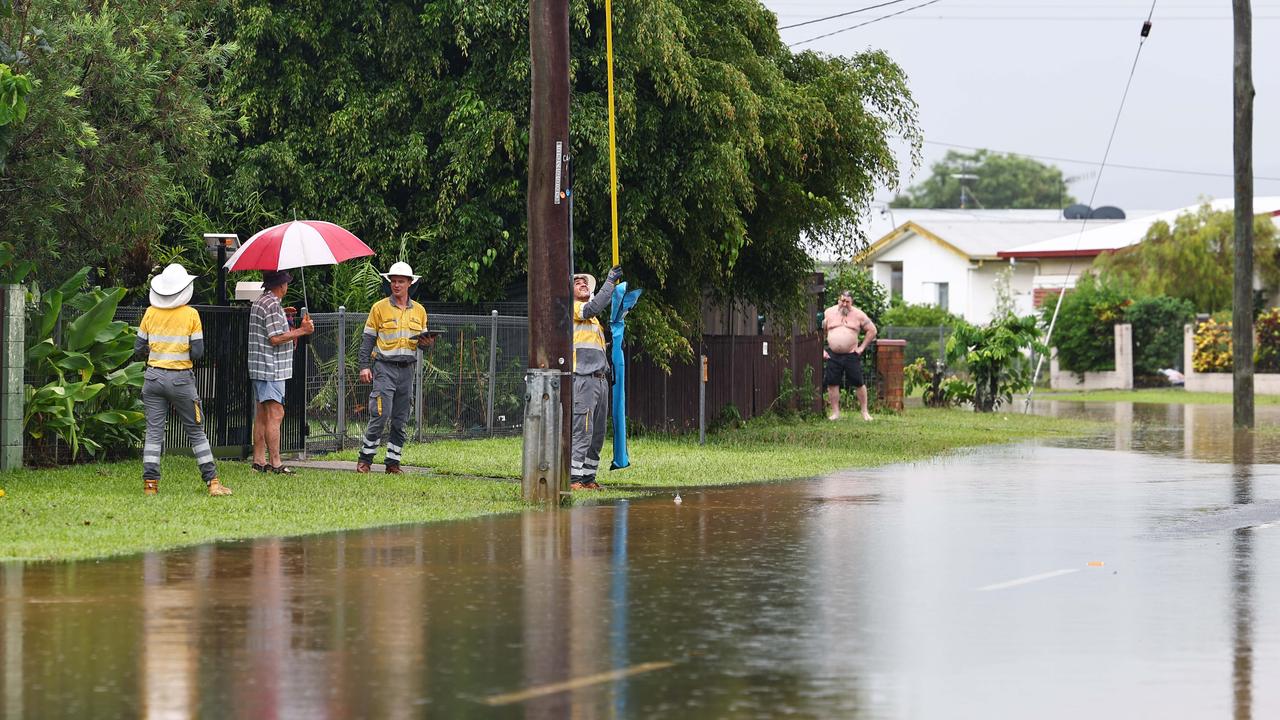 Ergon Energy workers look to restore power to Campbell Street in Gordonvale after heavy rain caused flooding to the area south of Cairns. Picture: Brendan Radke