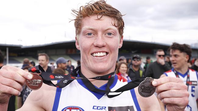 Matthew Rowell poses with his dual medals after winning best on ground in the NAB League grand final.