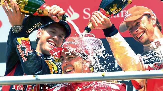 Fernando Alonso, centre, is sprayed with champagne by then second-placed German Sebastian Vettel, left, and Jenson Button.