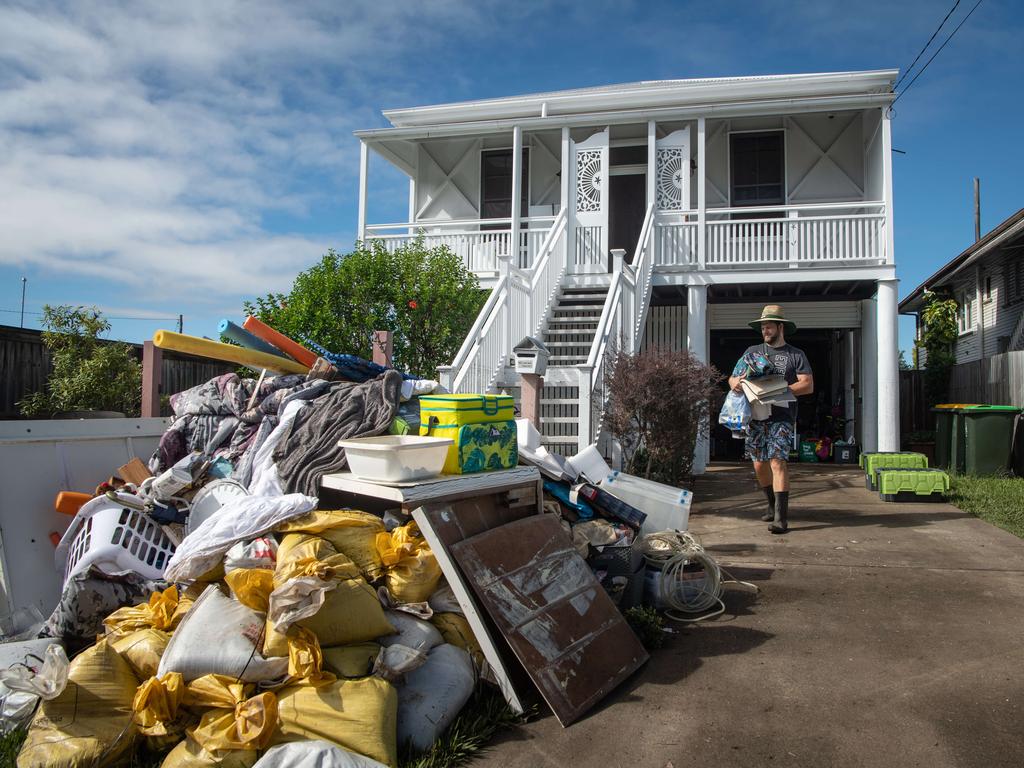 Murray Thomas adds to the rubbish pile in at the front of his Blackmore street home. Picture: Brad Fleet