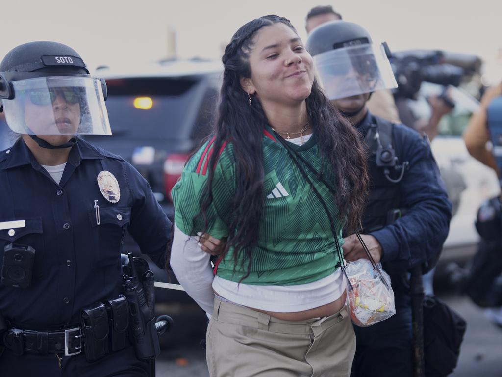 A protester is detained near the metropolitan detention centre of downtown Los Angeles. Picture: AP
