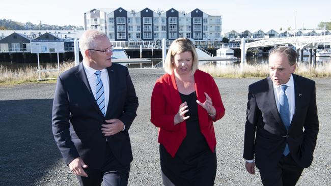 Scott Morrison talks to Bass Liberal candidate Bridget Archer, centre, and Health Minister Greg Hunt, right, at the North Esk Rowing Club in Tasmania yesterday. Picture: AAP