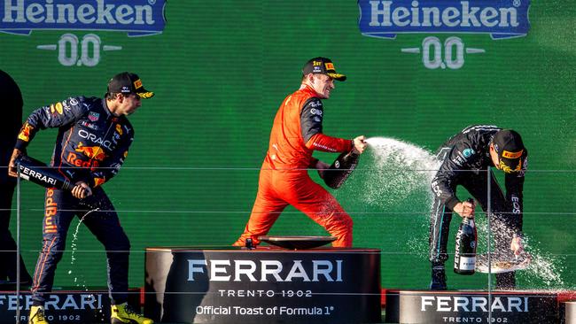 Charles Leclerc celebrates on the podium after saluting in Melbourne. Picture: Jake Nowakowski