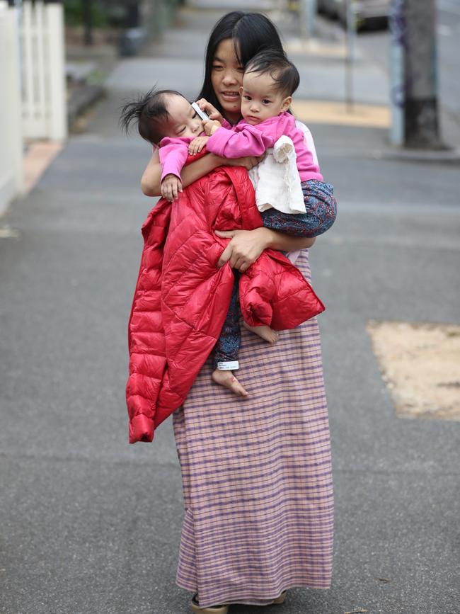 Mum Bhumchu Zangmo holds Nima [right], and Dawa [left] on their way home from the Royal Children's Hospital. Picture: Alex Coppel