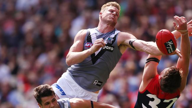  Tom Jonas at full stretch to spoil Melbourne’s Tom Sparrow on Saturday. Picture: Michael Dodge/Getty Images