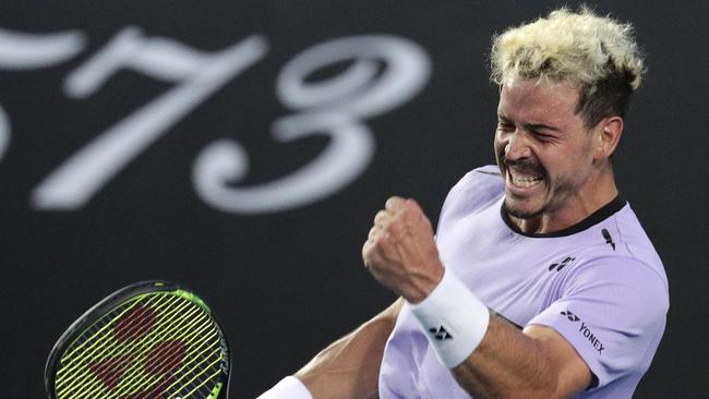 Australia's Alex Bolt celebrates after winning the fourth set against France's Gilles Simon. Picture: AP