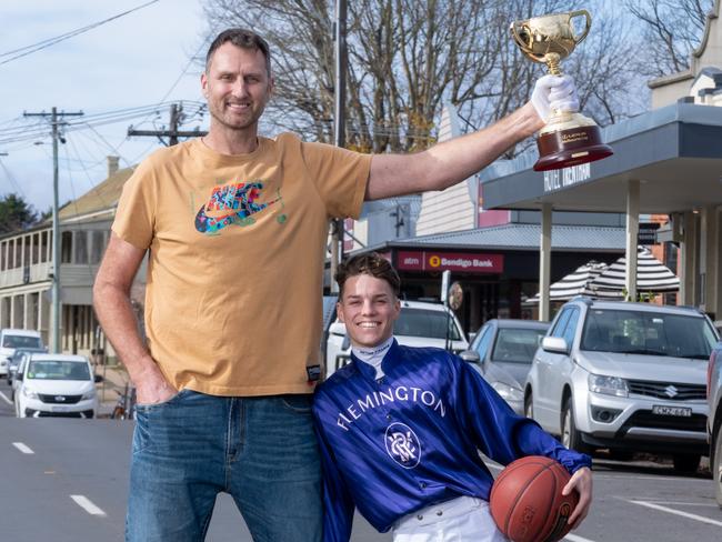 The Lexus Melbourne Cup trophy with successful 2024 Lexus Melbourne Cup Tour representative and Hall of Fame basketball player Chris Anstey and jockey Will Price in Trentham. Picture: Jay Town