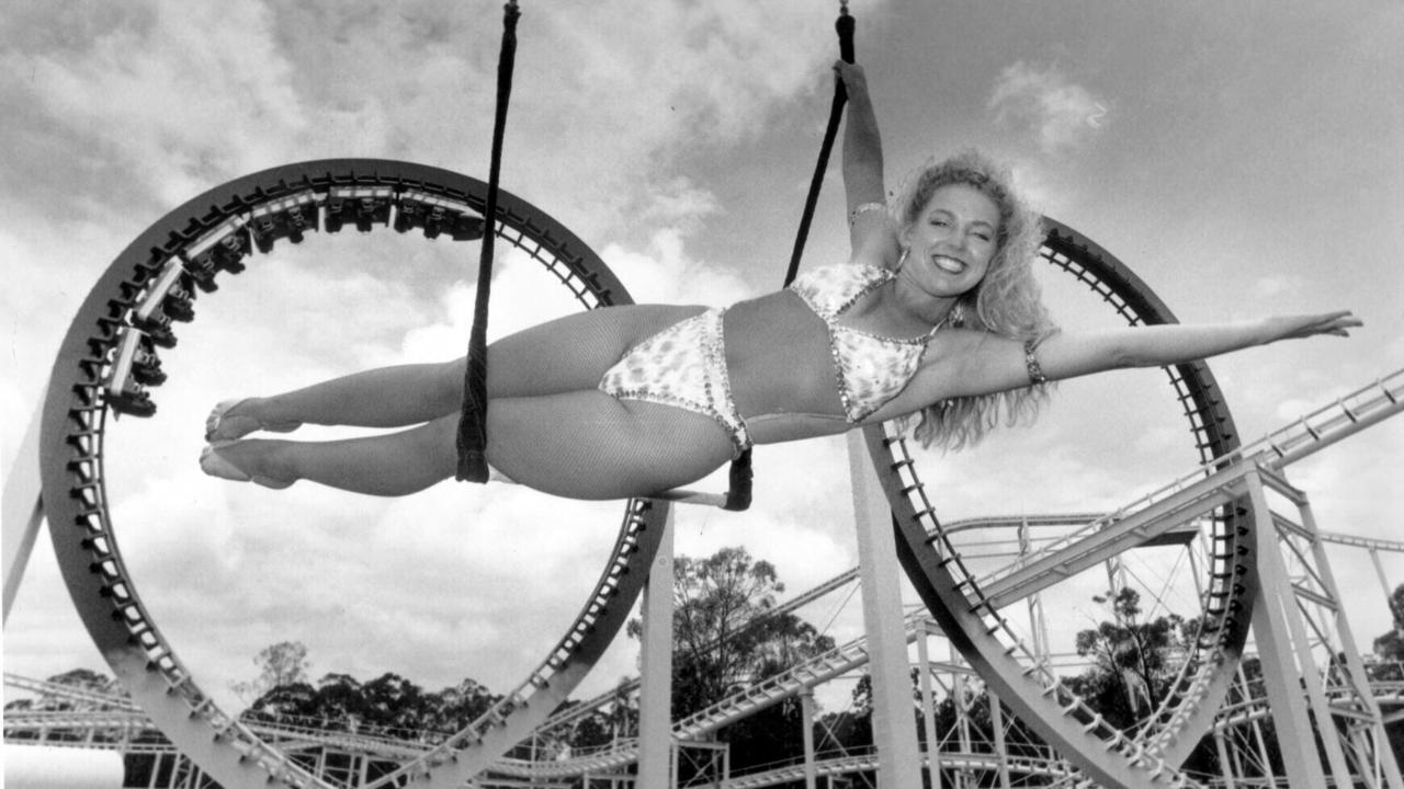 Trapeze artist Joanne De Gold with Thunderbolt ride in background at Dreamworld. 16/12/92, Pic: David Caird. Queensland (Qld) / Amusement Centre Travel