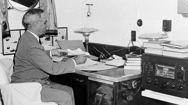 US president Harry S. Truman reads reports of the first atomic bomb raid on Japan, while en route home from the Potsdam conference. Picture: AP