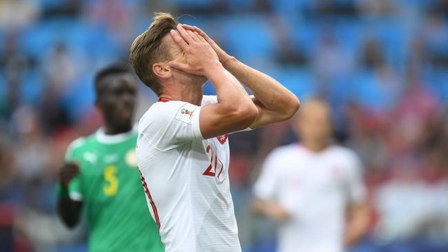 Polish defender Lukasz Piszczek reacts during a shock defeat to Senegal. Pic: AFP