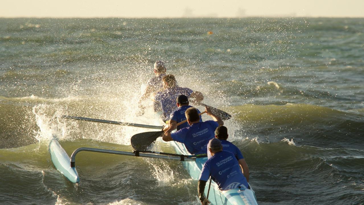 Outrigger Whitsunday Men brace for a set of two waves.