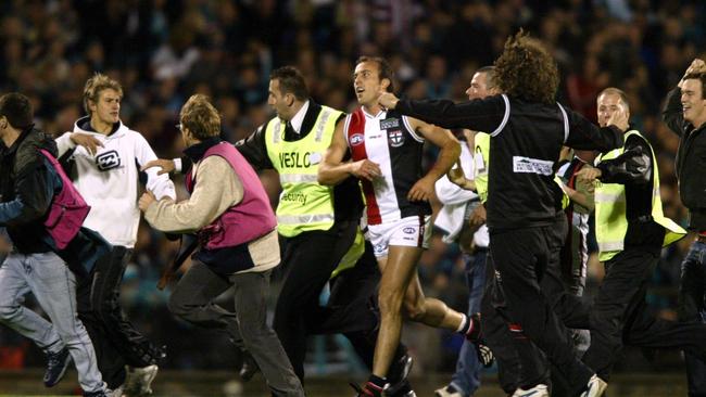 Fans flock on to the ground after St Kilda’s Fraser Gehrig kicks his 100th goal for the season during the 2004 preliminary final.