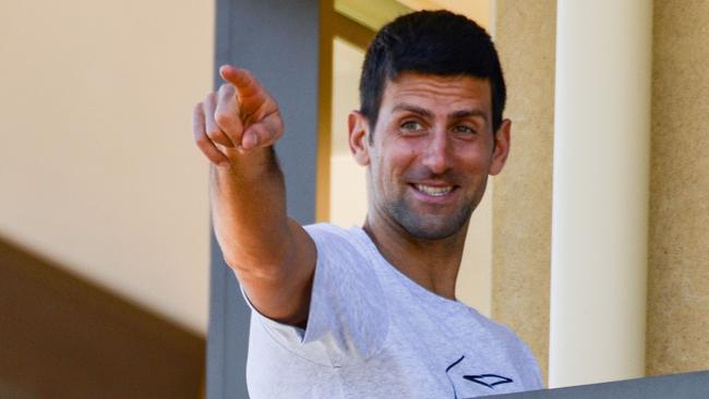 Men's world number one Novak Djokovic gestures from his hotel balcony in Adelaide. Picture: Brenton Edwards/AFP