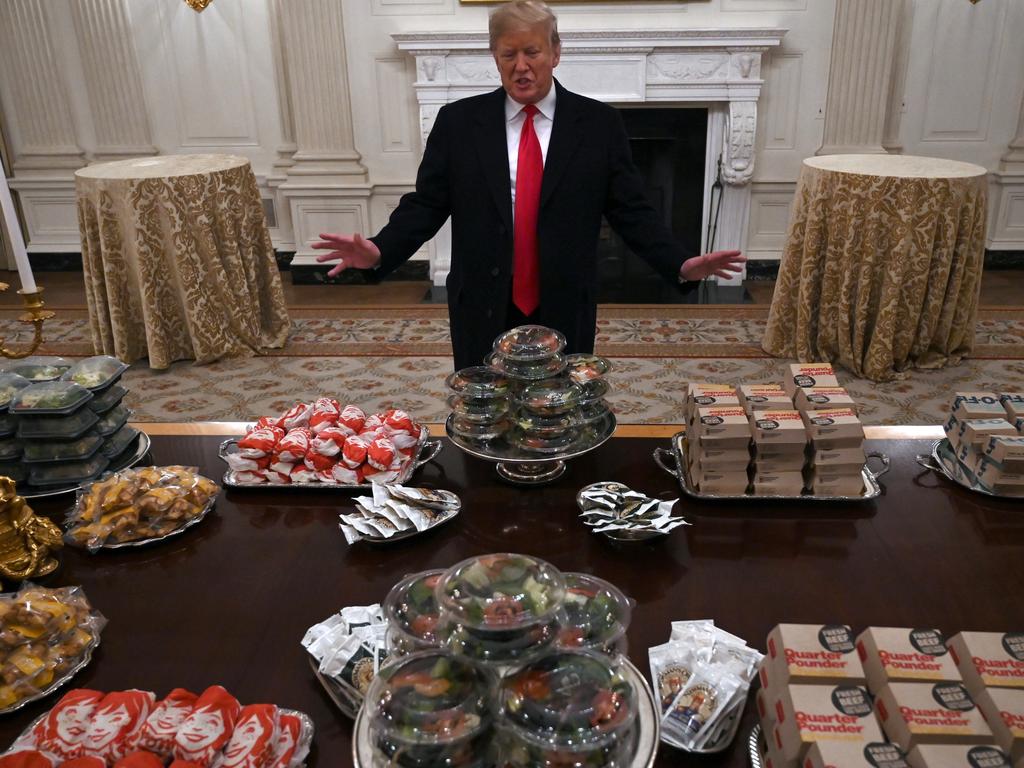 President Donald Trump talks to the media about the table full of fast food in the State Dining Room of the White House in Washington, for the reception for the Clemson Tigers on January 14. Picture: AP