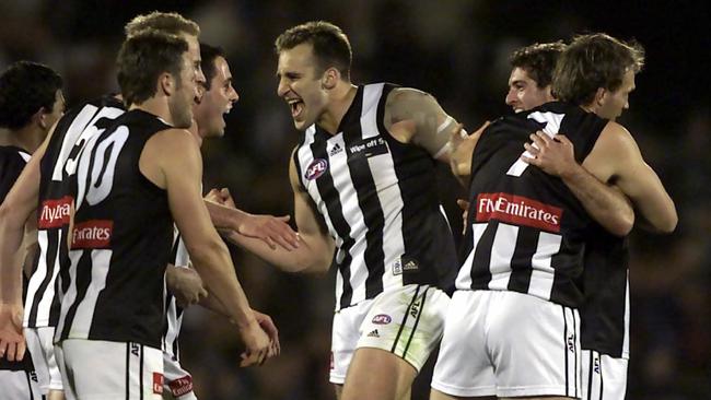 Ecstatic Collingwood players celebrate victory over Port Adelaide in the qualifying final in 2002.