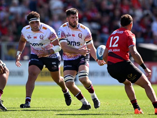 Liam Wright (centre) passes the ball during Queensland’s 43-19 loss to the Crusaders. Picture: Joe Allison/Getty Images