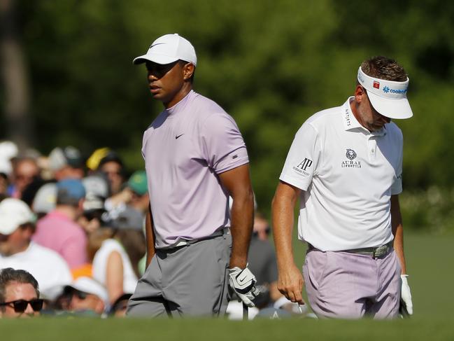 AUGUSTA, GEORGIA - APRIL 13: Ian Poulter of England and Tiger Woods of the United States walk on the 12th hole during the third round of the Masters at Augusta National Golf Club on April 13, 2019 in Augusta, Georgia. (Photo by Kevin C. Cox/Getty Images)