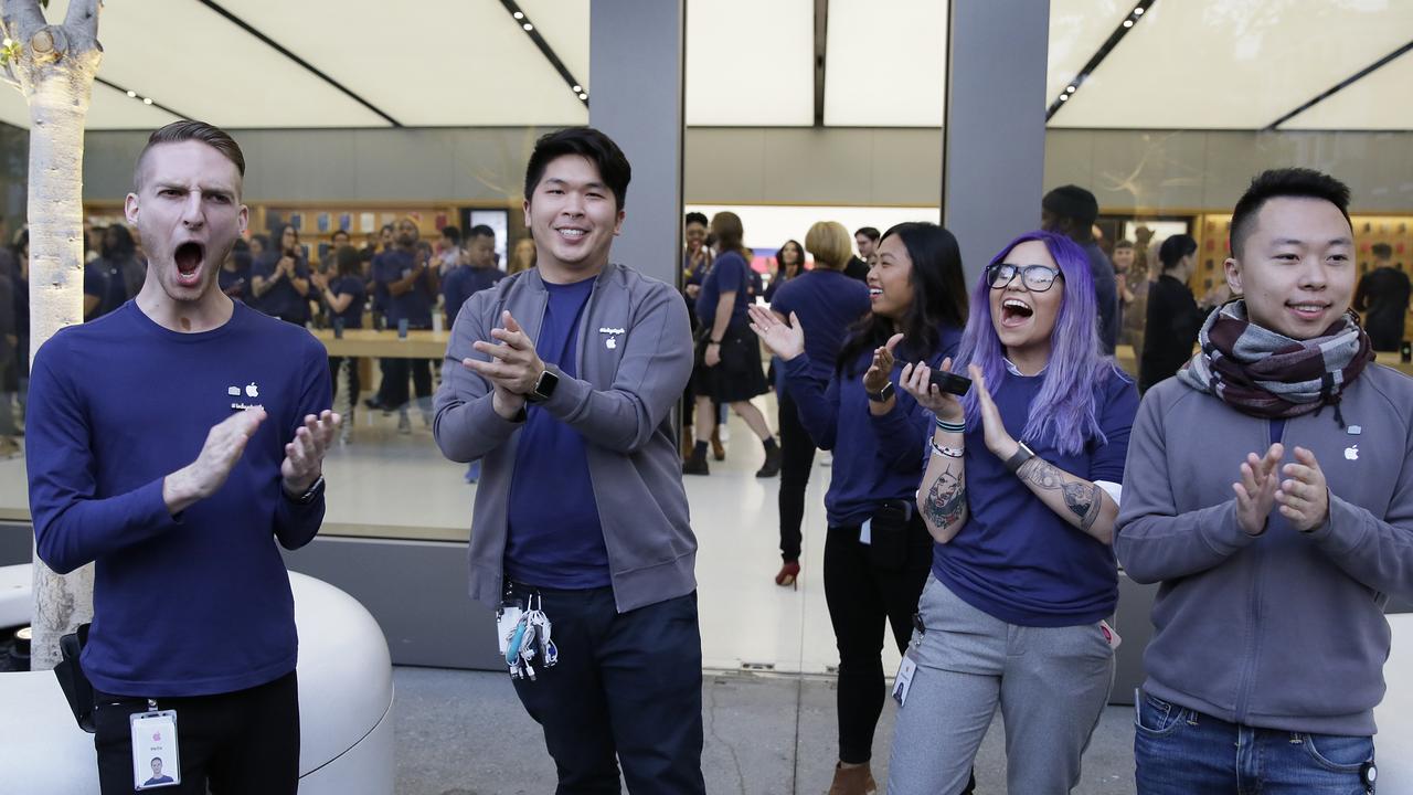 The workers in this photo outside a San Francisco Apple store could be given back payments for the time it took to search their bags each day. Picture: AP Photo/Eric Risberg