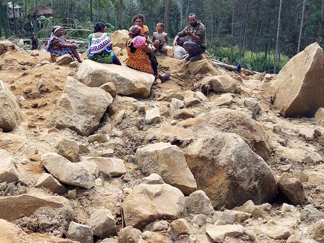 Family members of missing villagers at the site of the landslide at Mulitaka village in the region of Maip Mulitaka, in Papua New Guinea's Enga Province on May 26. Picture: AFP