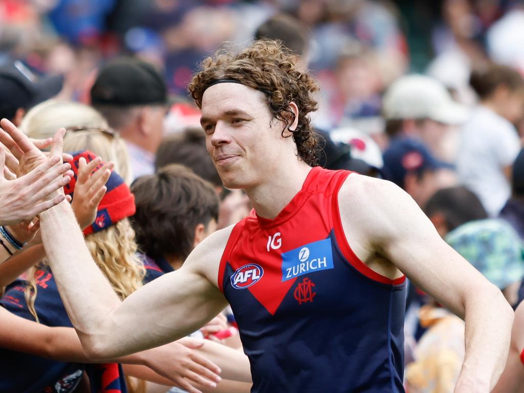 MELBOURNE, AUSTRALIA - MARCH 17: Ben Brown of the Demons celebrates a win with fans during the 2024 AFL Round 01 match between the Melbourne Demons and the Western Bulldogs at the Melbourne Cricket Ground on March 17, 2024 in Melbourne, Australia. (Photo by Dylan Burns/AFL Photos via Getty Images)