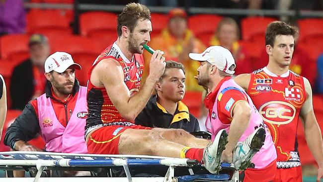 Gold Coast’s Michael Barlow uses pain relief to deal with his broken leg suffered against Carlton. (Photo by Chris Hyde/Getty Images)