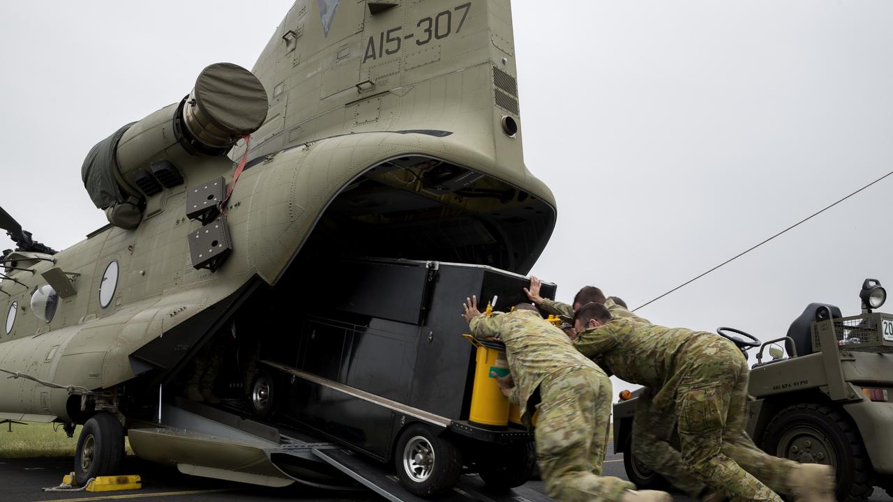 Australian Army soldiers from 5th Aviation Regiment load equipment onto a CH-47 Chinook helicopter during Operation Bushfire Assist. *** Local Caption *** The Australian Defence Force (ADF) is continuing support to State and Territory agencies and local communities under Operation Bushfire Assist 19-20. Three Joint Task Forces have been established to facilitate ADF support to emergency services in Victoria, New South Wales and South Australia. The ADF is working alongside government and civilian agencies at all levels in support to the firefighting, relief and recovery effort by providing humanitarian, transport and other assistance such as aviation, route clearance, logistics, veterinary assistance, health services, engineering support and accommodation.