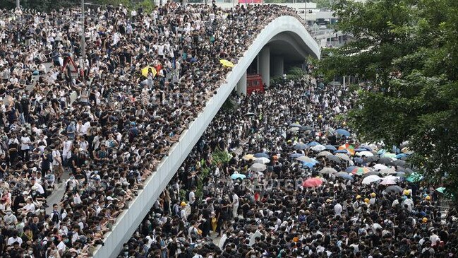 Demonstrators march along a Hong Kong road to protest against proposed extradition bill. Picture: Reuters