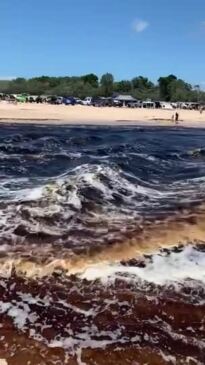 Water rushing from lagoon after breaking banks on Bribie Island