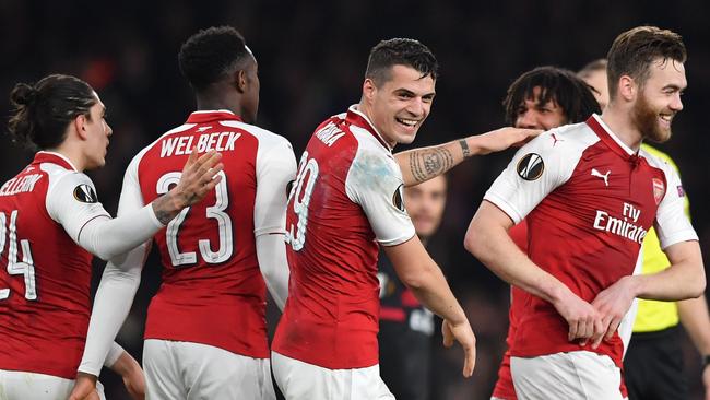 Arsenal's Swiss midfielder Granit Xhaka (C) celebrates with teammates.