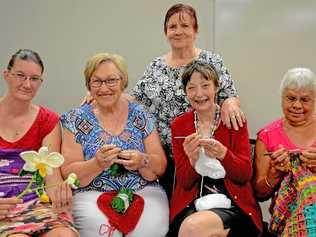 CLICK, CLICK: From left, Toulouse Casey, Edie Bellis, Mary Fulwood, Judith Houlahan and (at back) Bev Chelepy meet at the South Rockhampton Library to craft warm ware for locals in need. Picture: Jann Houley