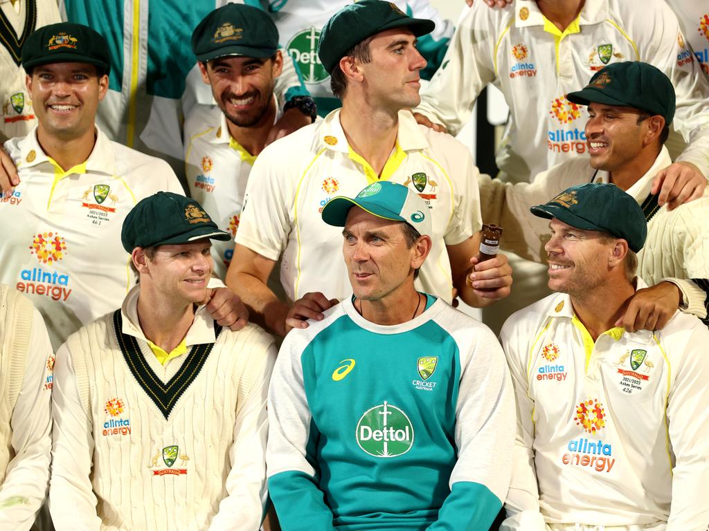 Justin Langer sits among his players after completing a 4-0 Ashes series win, a triumph that has still not secured his future as coach. Picture: Robert Cianflone/Getty Images